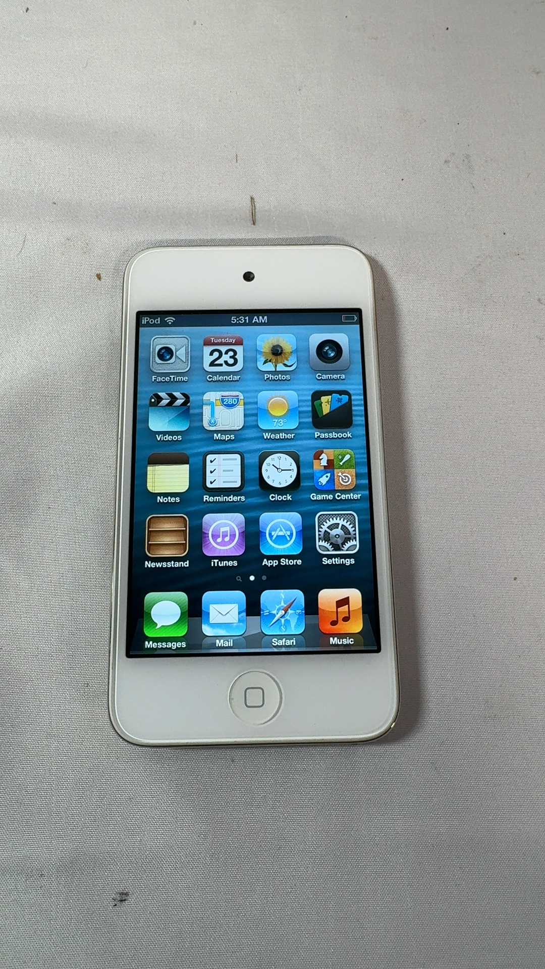 Real test-item source photo of a powered-on white iPod touch